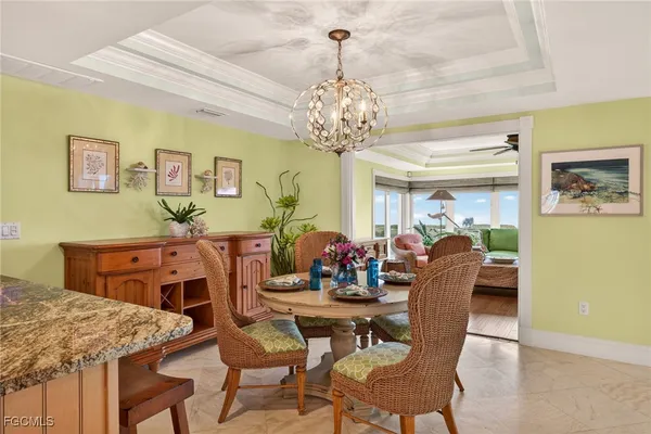 a view of a dining room with furniture and a chandelier