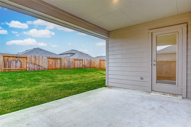 a view of a house with a yard and pathway