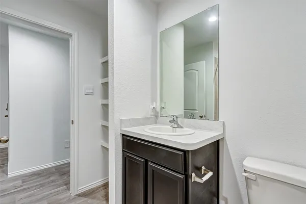 a bathroom with a sink toilet and mirror