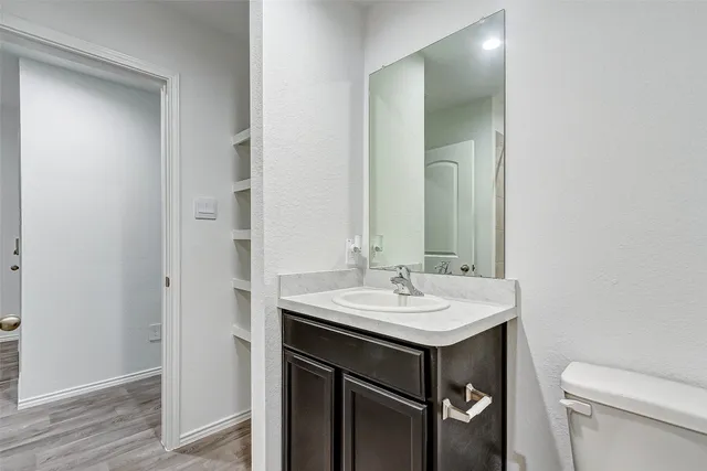 a bathroom with a sink toilet and mirror