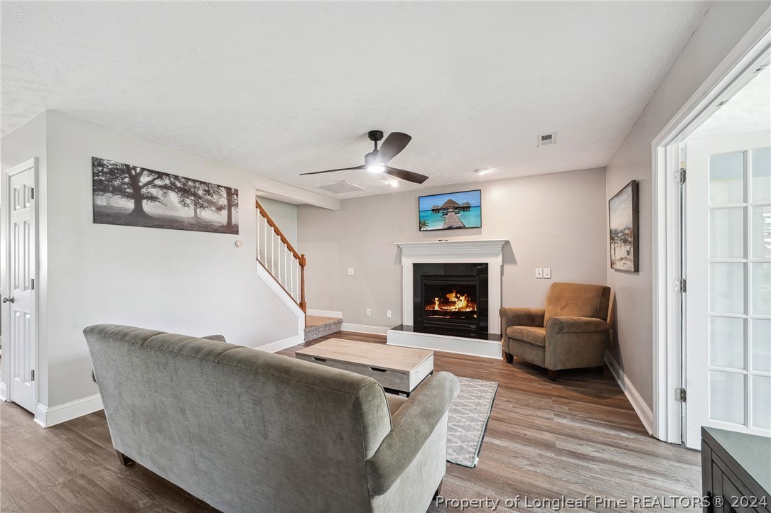 176 Vandercroft Way Bunnlevel, NC 28323 - Photo 14 of 36 a living room with furniture and a fireplace