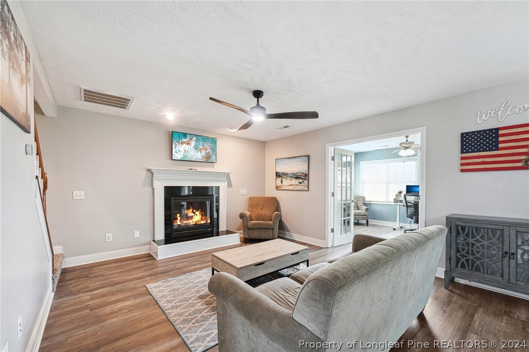 176 Vandercroft Way Bunnlevel, NC 28323 - Photo 15 of 36 a living room with furniture and a fireplace