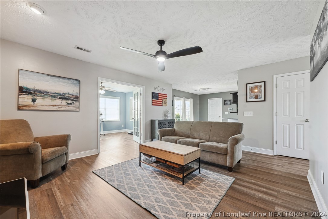 176 Vandercroft Way Bunnlevel, NC 28323 - Photo 16 of 36 a living room with furniture a rug and a table