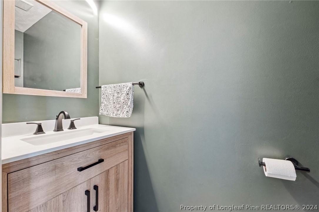 176 Vandercroft Way Bunnlevel, NC 28323 - Photo 18 of 36 a bathroom with a sink vanity and a mirror
