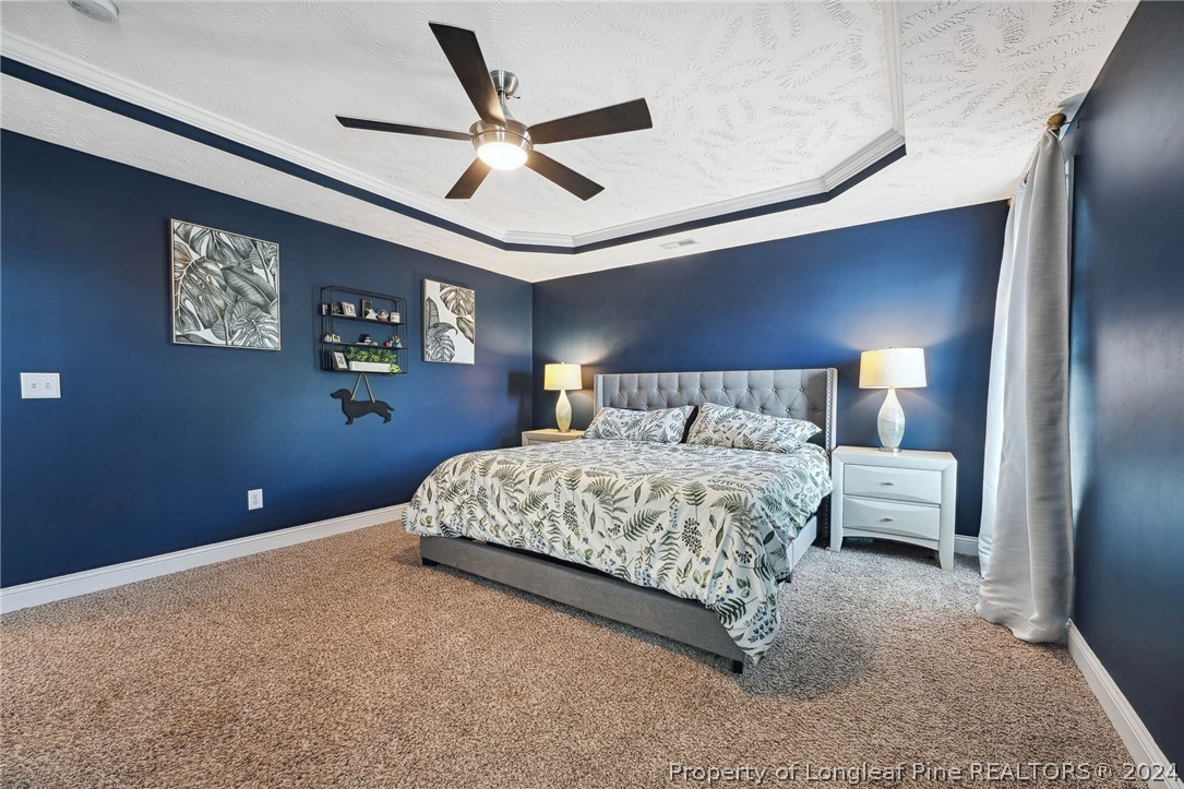 176 Vandercroft Way Bunnlevel, NC 28323 - Photo 20 of 36 a bedroom with a bed and a large mirror
