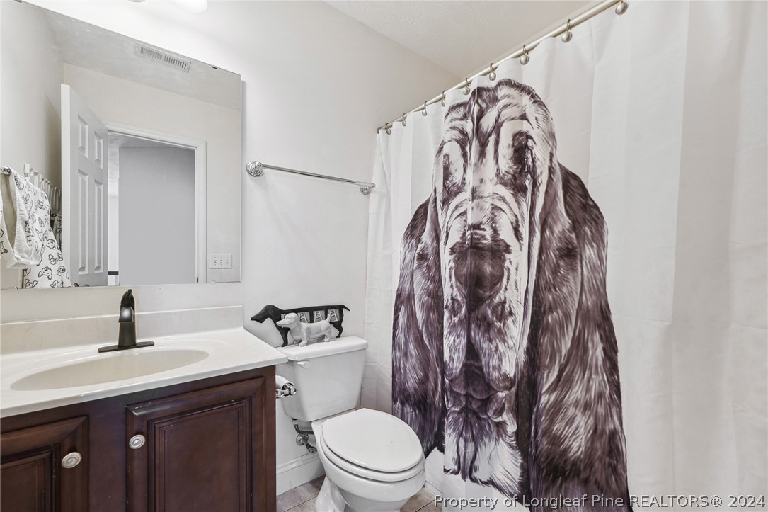 176 Vandercroft Way Bunnlevel, NC 28323 - Photo 25 of 36 a bathroom with a toilet sink and mirror