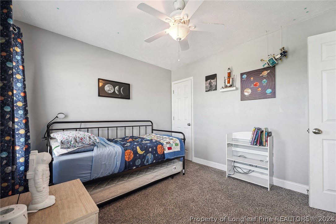 176 Vandercroft Way Bunnlevel, NC 28323 - Photo 27 of 36 a bedroom with furniture and a window