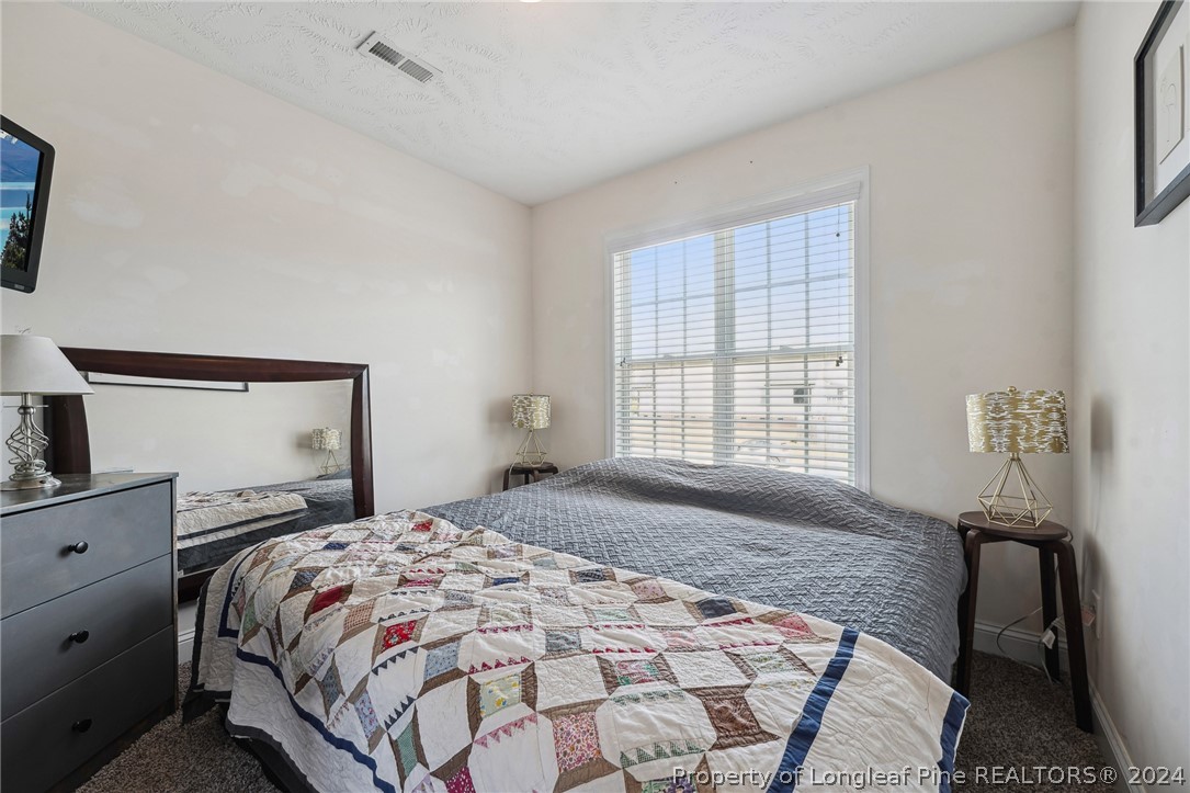 176 Vandercroft Way Bunnlevel, NC 28323 - Photo 30 of 36 a bedroom with a bed and a window