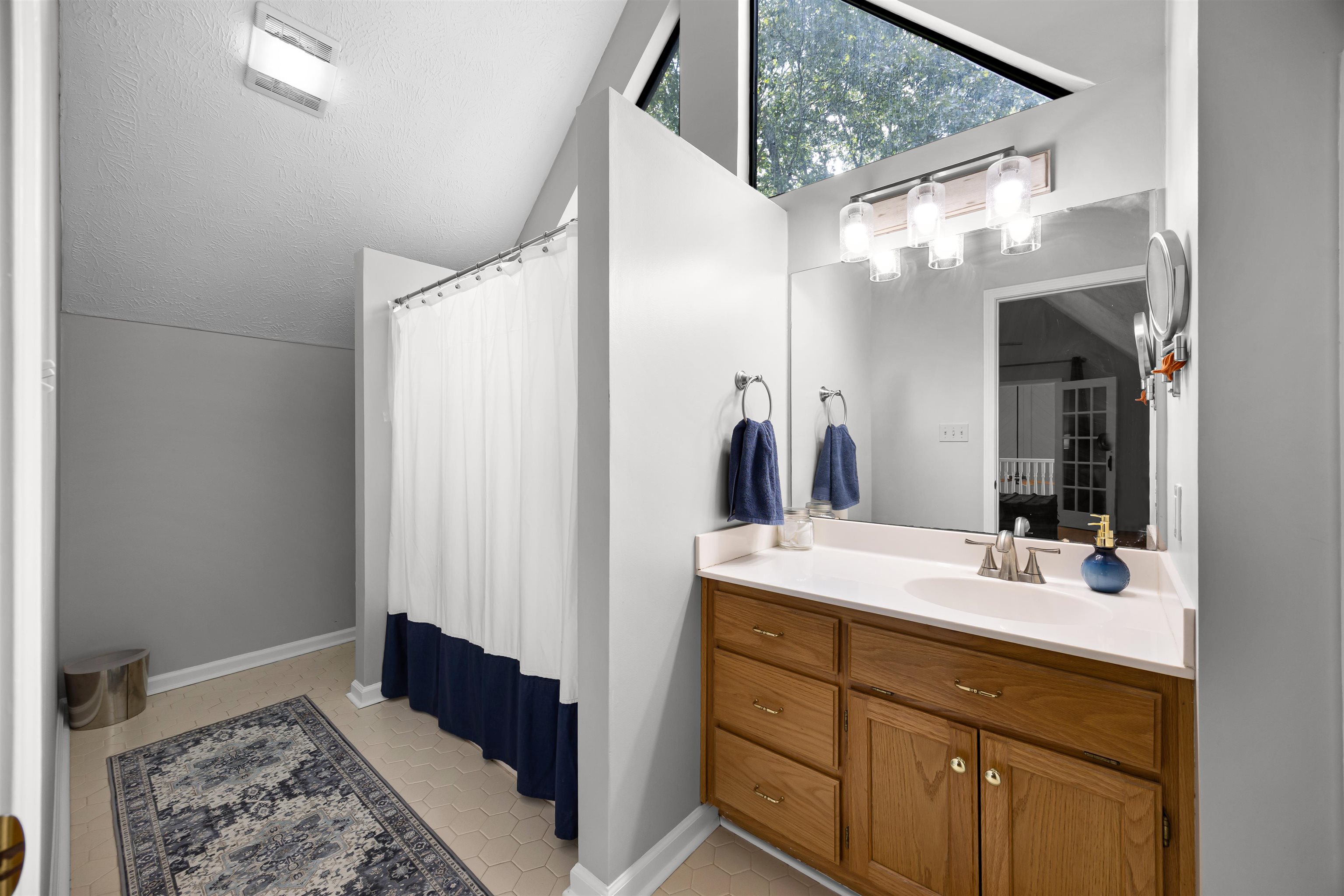 70 Point Clear Cove Savannah, TN 38372 - Photo 26 of 26 Full bathroom with vanity, light tile patterned flooring, vaulted ceiling
