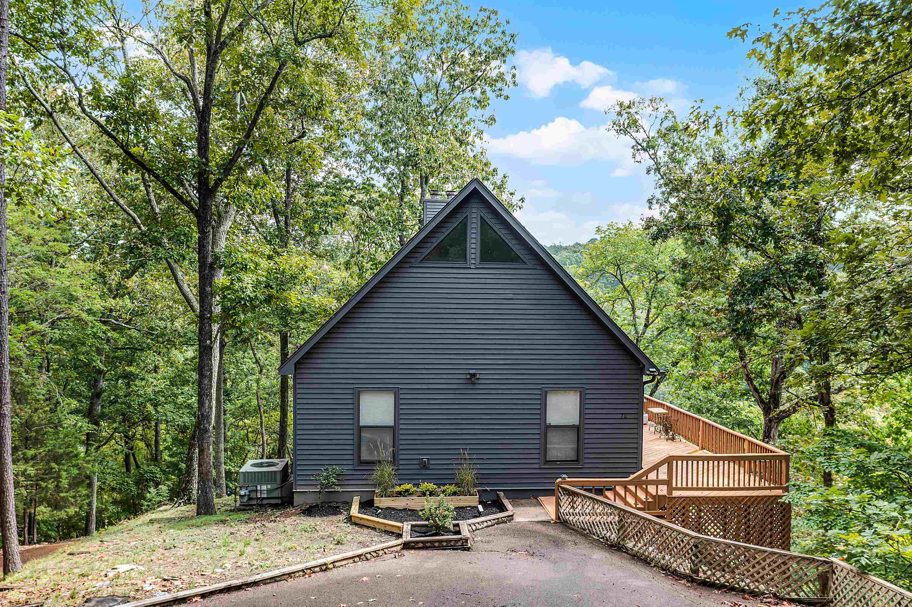 70 Point Clear Cove Savannah, TN 38372 - Photo 3 of 25 Rear view of house featuring a wooden deck, a vegetable garden, and a view of trees
