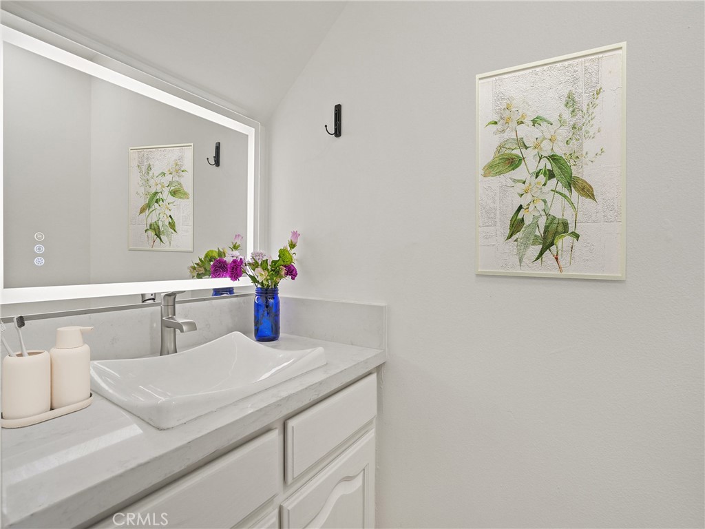 1 3rd Place, Unit 2 Long Beach, CA 90802 - Photo 14 of 55 a bathroom with a sink a mirror and painting on the wall