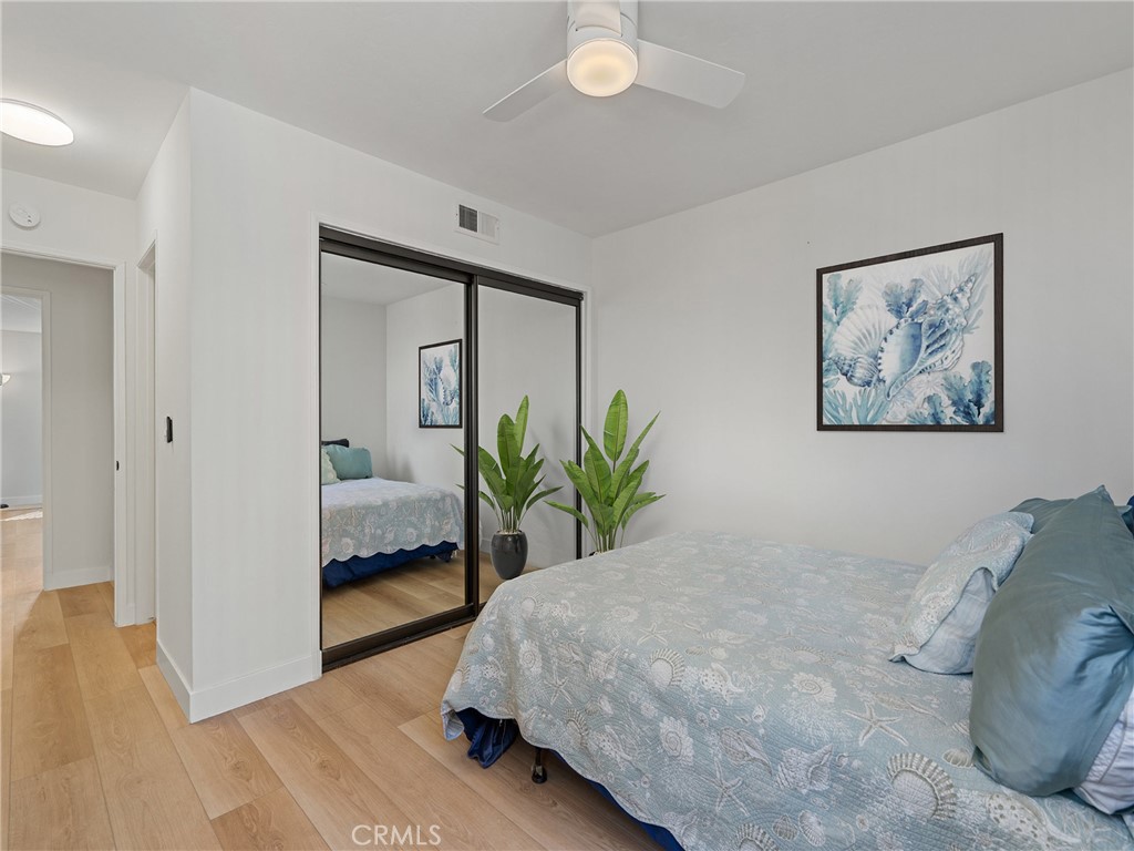 1 3rd Place, Unit 2 Long Beach, CA 90802 - Photo 15 of 55 a bedroom with a large bed and a potted plant