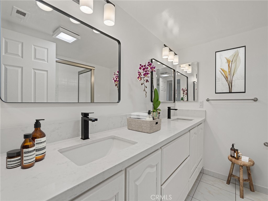 1 3rd Place, Unit 2 Long Beach, CA 90802 - Photo 17 of 55 a bathroom with a sink and a mirror