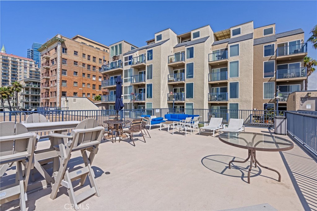 1 3rd Place, Unit 2 Long Beach, CA 90802 - Photo 27 of 55 a view of a dinning table and chairs in the patio