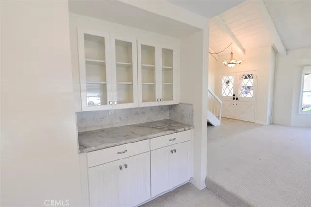 a kitchen with a granite countertop sink and cabinets