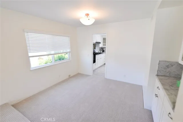 a view of a livingroom with furniture and a window