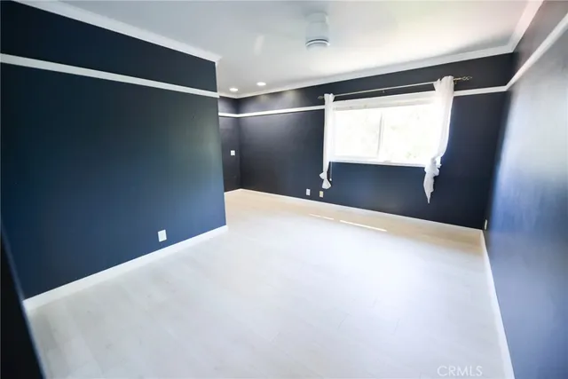 a view of an empty room with window and air conditioner