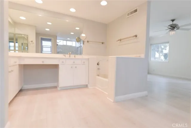 a view of cabinets a faucet a sink and a stove in it
