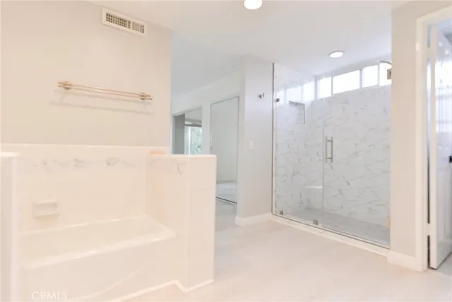 a bathroom with a bathtub and shower