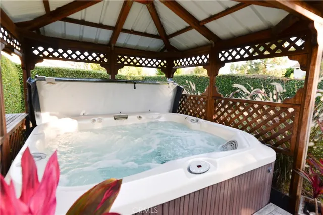 a bed room with a large bed and a chandelier