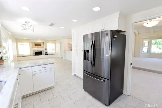 a kitchen with stainless steel appliances a refrigerator sink and cabinets