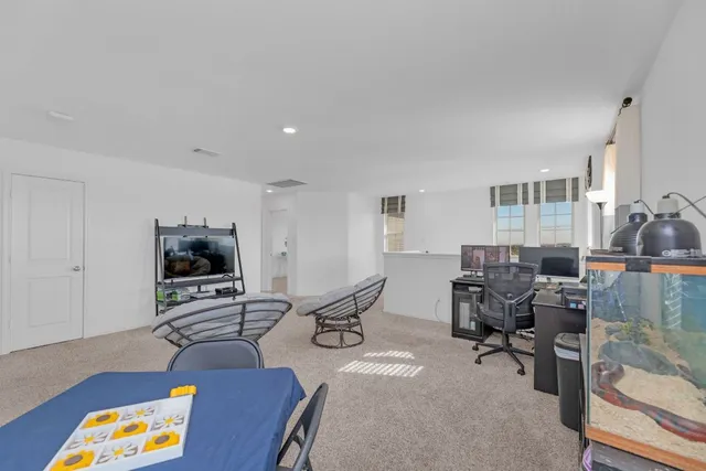 a living room with furniture a rug and a flat screen tv