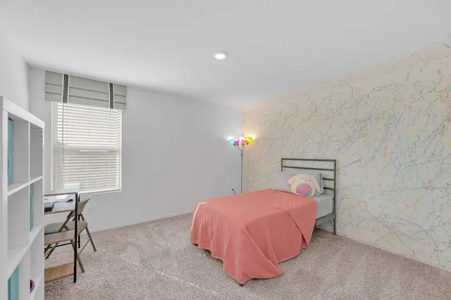 a bedroom with a bed and a window