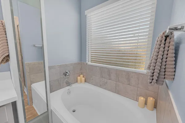 a bathroom with a white bath tub and a shower