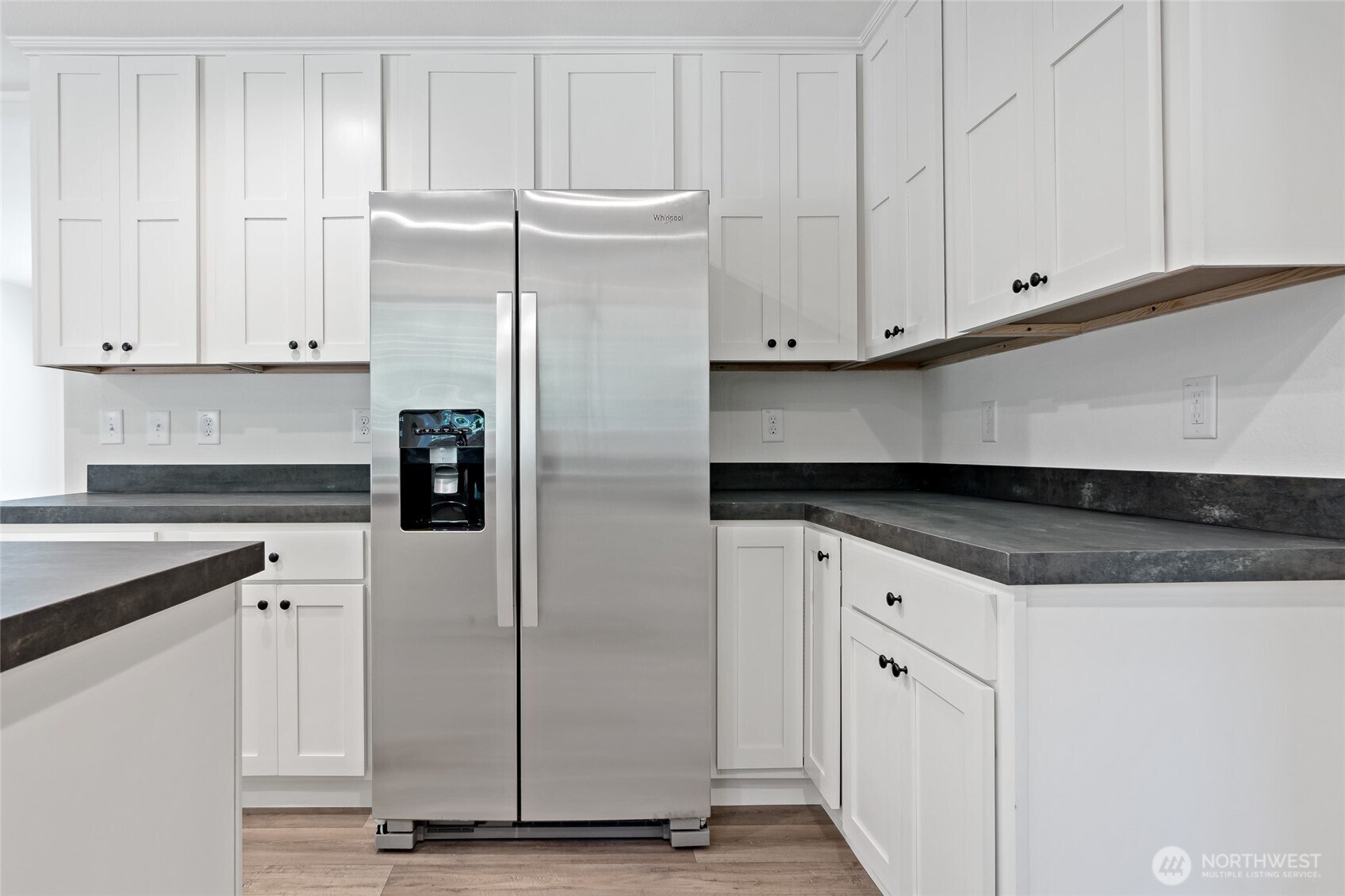 17217 80th Street Southwest Longbranch, WA 98351 - Photo 11 of 39 a kitchen with granite countertop white cabinets and refrigerator