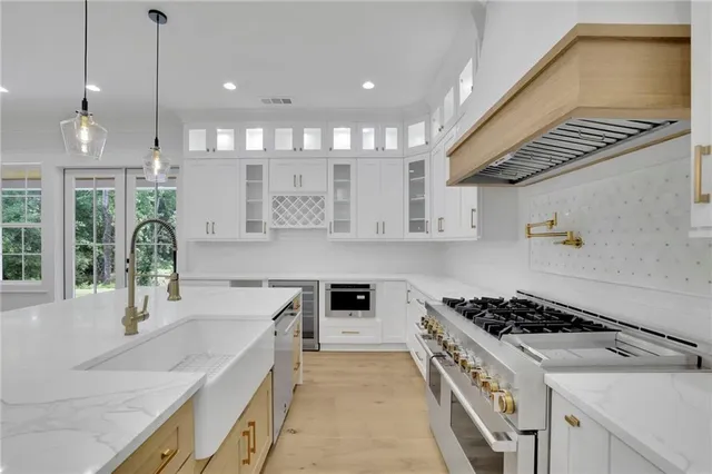 a view of an empty room with a kitchen view
