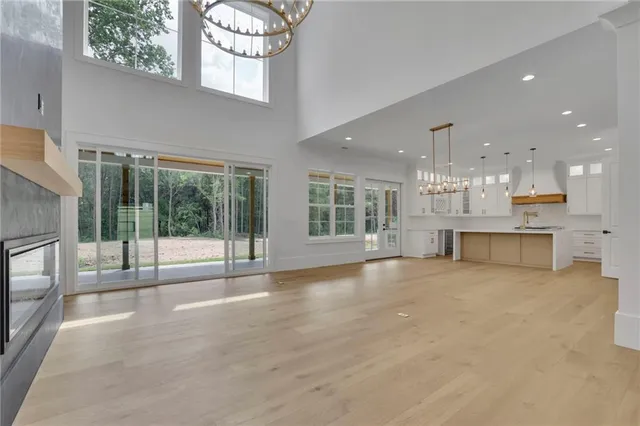 a view of staircase with railing and a chandelier