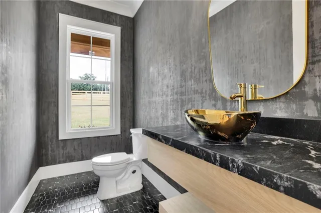 a view of an empty room with furniture and window