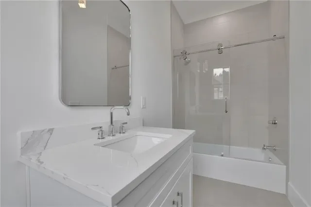 a view of an empty room with a window and chandelier fan