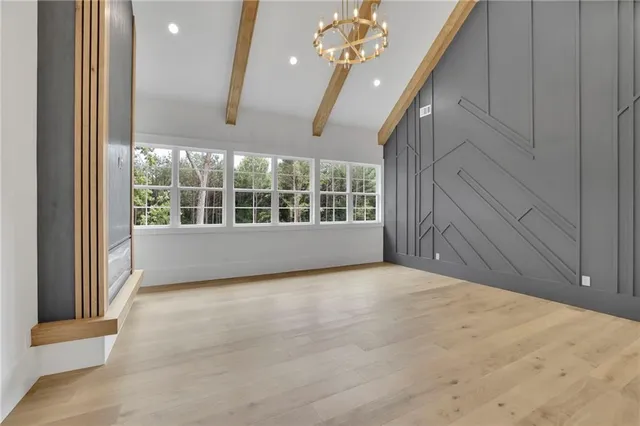 an empty room with closet and a ceiling fan