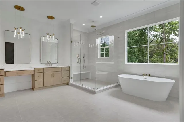 a spacious bathroom with a granite countertop sink a toilet a large mirror and vanity