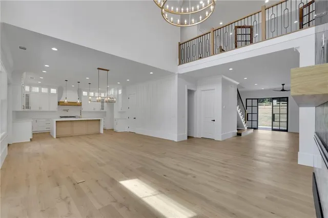 a large kitchen with granite countertop a large counter top a sink stainless steel appliances and cabinets