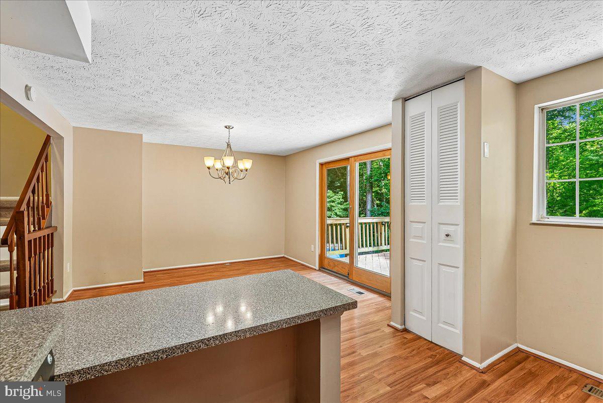 2331 Middle Creek Lane Reston, VA 20191 - Photo 23 of 78 a view of an empty room with wooden floor and a window