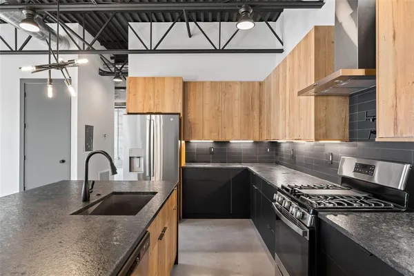 a kitchen with a sink a stove and cabinets