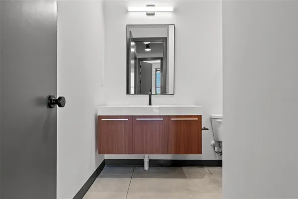 a bath tub sitting next to a white toilet and a shower