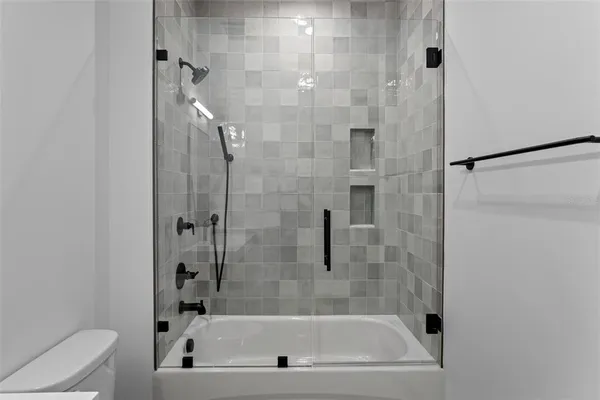 a bathroom with a shower toilet and sink