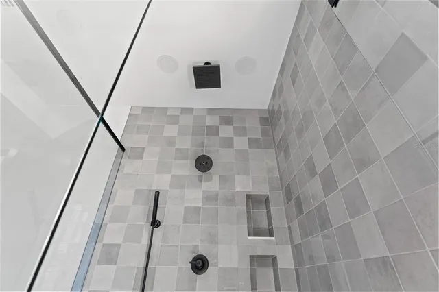a bathroom with a glass shower door