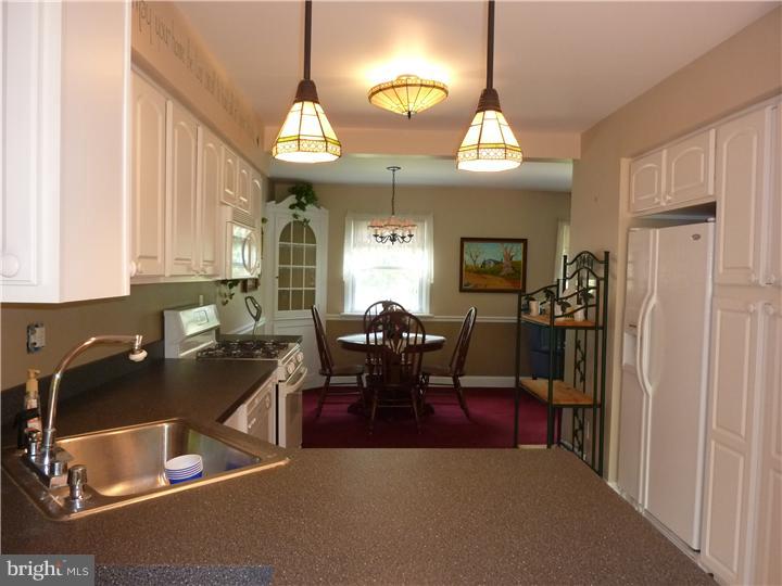 18 Warwick Road Stratford, NJ 08084 - Photo 3 of 25 a view of a dining room with furniture and a chandelier