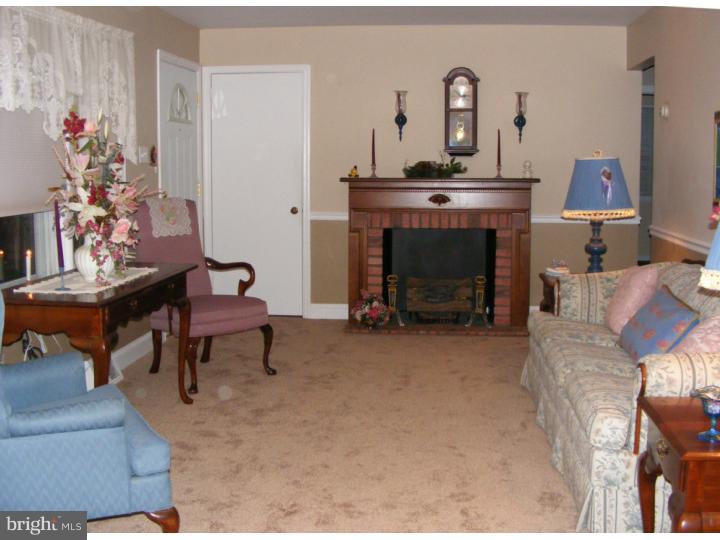 18 Warwick Road Stratford, NJ 08084 - Photo 8 of 25 a living room with furniture and a fireplace
