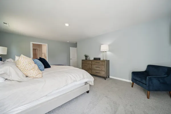 a bedroom with a bed and dresser