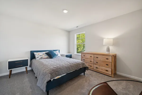 a bedroom with a bed and a dresser