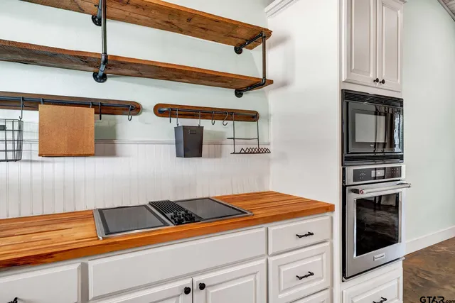 a kitchen view of a stove and a microwave