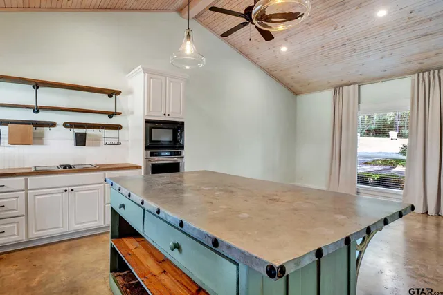 a kitchen with a stove a refrigerator and a sink