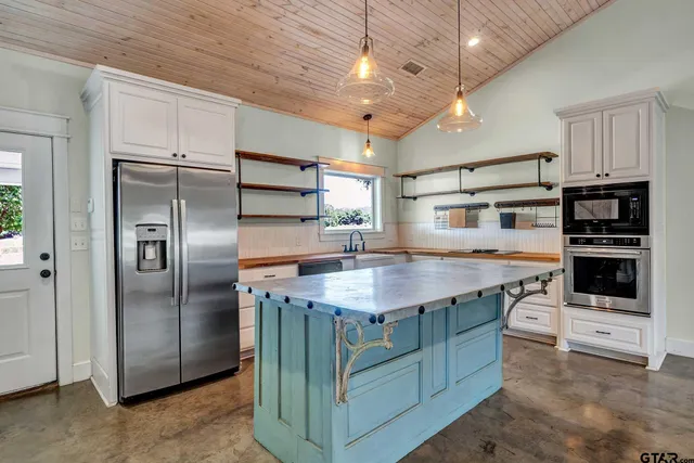 a kitchen with cabinets and stainless steel appliances