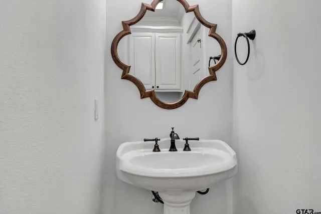 a bathroom with a sink and mirror