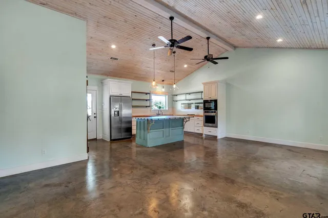a view of a kitchen with a sink and a refrigerator